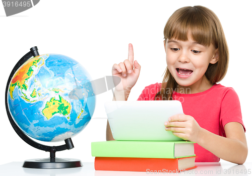 Image of Young girl is using tablet