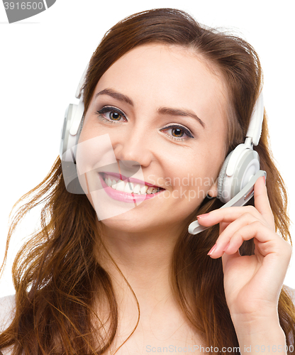 Image of Lovely young woman is talking to customers