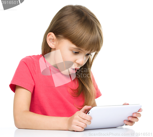 Image of Young girl is using tablet