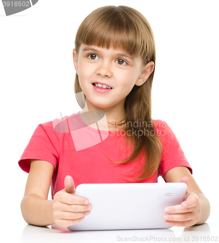 Image of Young girl is using tablet