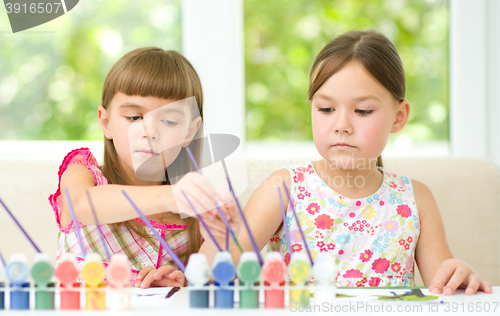 Image of Little girls are painting with gouache