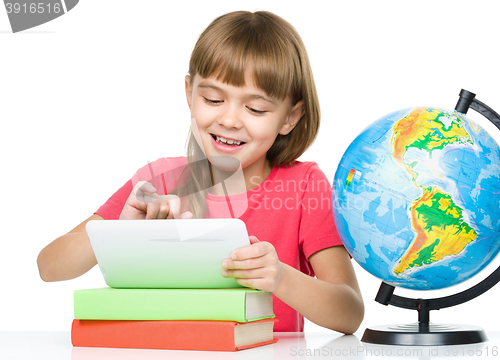 Image of Young girl is using tablet