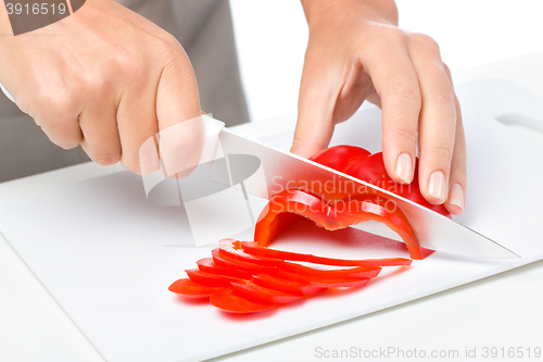 Image of Cook is chopping bell pepper