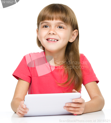 Image of Young girl is using tablet