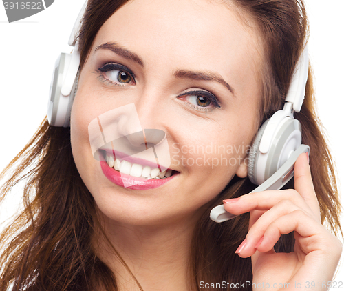 Image of Lovely young woman is talking to customers