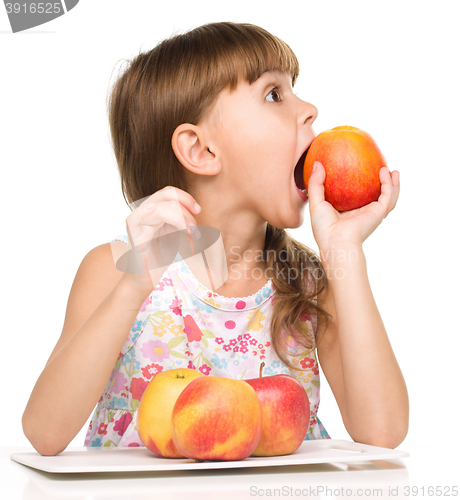 Image of Little girl with red apples