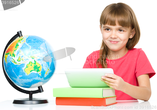 Image of Young girl is using tablet