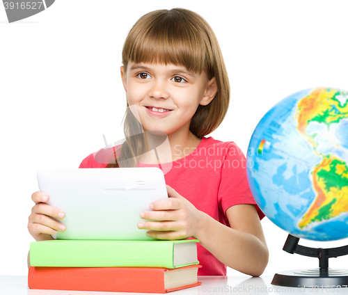 Image of Young girl is using tablet