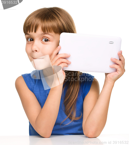 Image of Young cheerful girl is using tablet