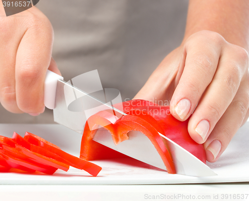 Image of Cook is chopping bell pepper