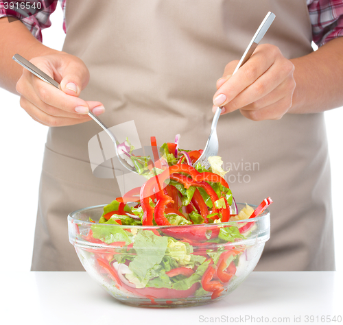 Image of Cook is mixing salad