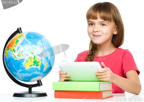 Image of Young girl is using tablet