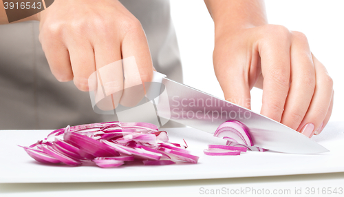 Image of Cook is chopping onion