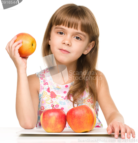Image of Little girl with red apples