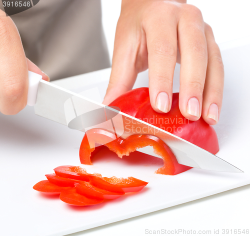 Image of Cook is chopping bell pepper