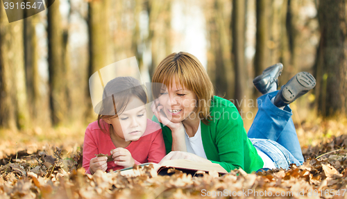 Image of Mother is reading book with her daughter