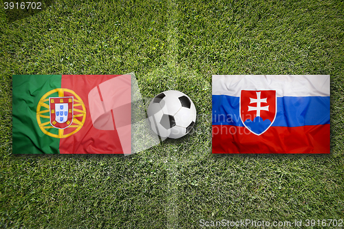 Image of Portugal vs. Slovakia flags on soccer field