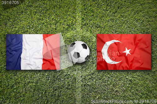 Image of France vs. Turkey flags on soccer field