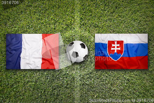 Image of France vs. Slovakia flags on soccer field