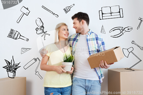 Image of smiling couple with big boxes moving to new home