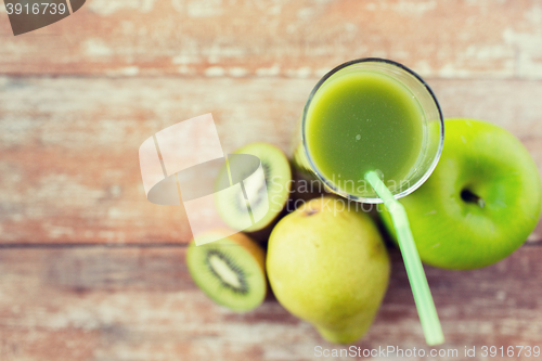 Image of close up of fresh green juice and fruits on table