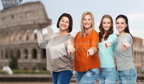 Image of group of happy women pointing finger over coliseum