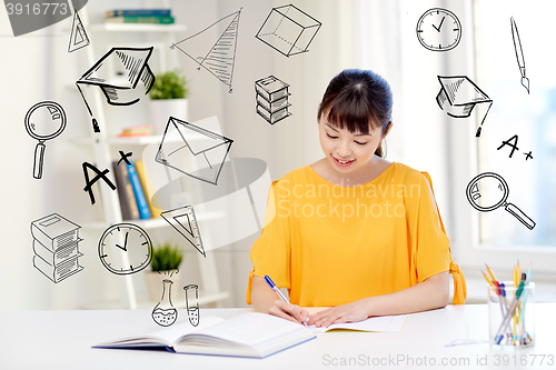 Image of happy asian young woman student learning at home