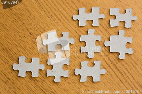 Image of close up of puzzle pieces on wooden surface