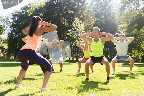 Image of group of friends or sportsmen exercising outdoors