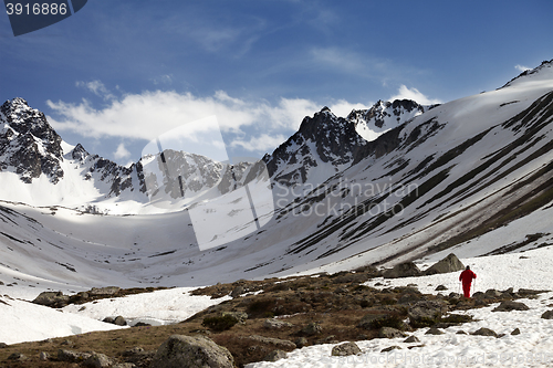 Image of Hiker at snowy mountains in evening
