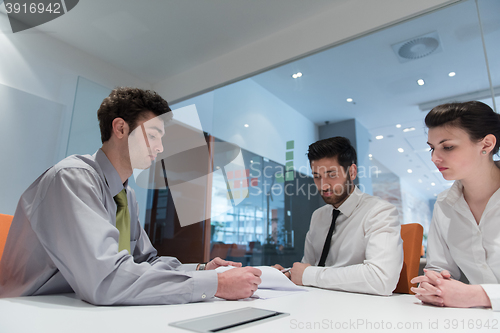 Image of young couple signing contract documents on partners back