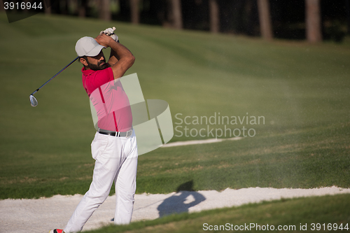 Image of golfer hitting a sand bunker shot