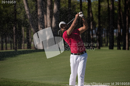 Image of golfer hitting a sand bunker shot