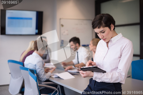 Image of business woman on meeting  using tablet