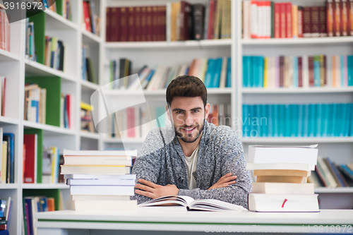 Image of portrait of student while reading book  in school library