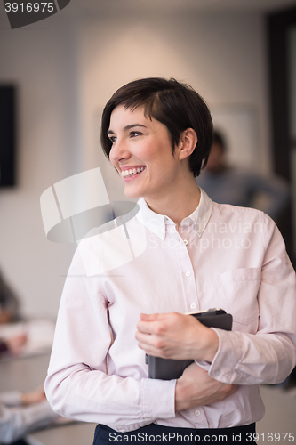 Image of hispanic businesswoman with tablet at meeting room