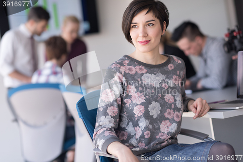 Image of portrait of young business woman at office with team on meeting 