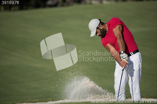 Image of golfer hitting a sand bunker shot