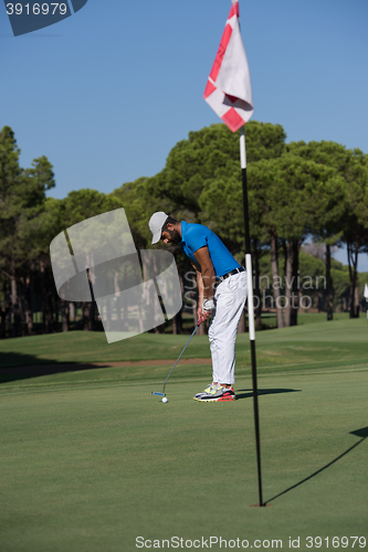 Image of golf player hitting shot at sunny day