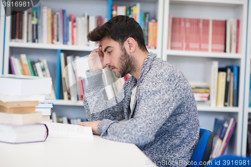 Image of portrait of student while reading book  in school library