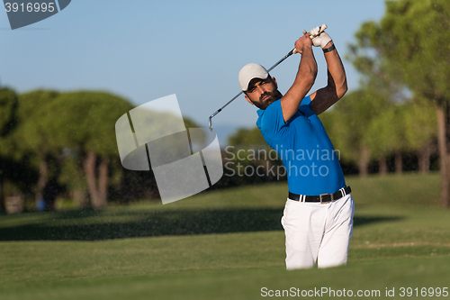 Image of pro golfer hitting a sand bunker shot