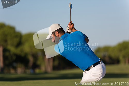 Image of pro golfer hitting a sand bunker shot