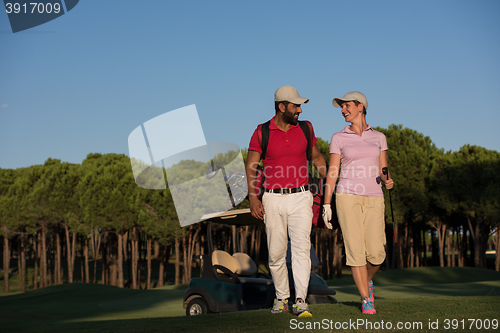 Image of couple walking on golf course