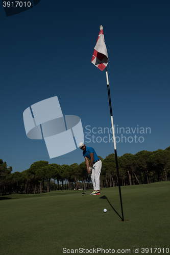 Image of golf player hitting shot at sunny day