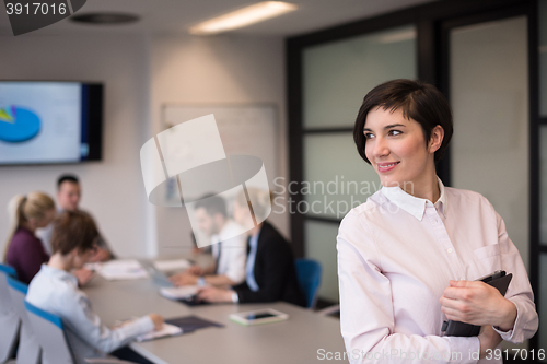 Image of hispanic businesswoman with tablet at meeting room