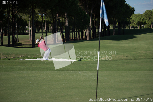 Image of golfer hitting a sand bunker shot