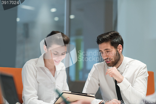 Image of young business couple working together on project