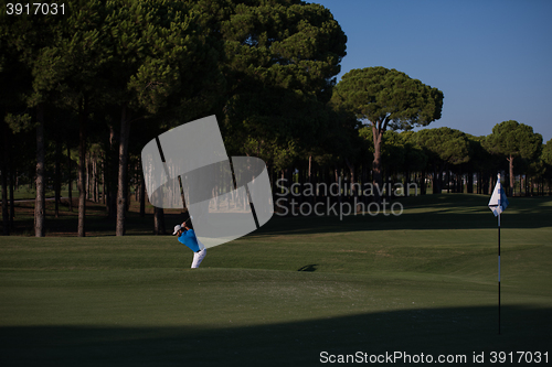 Image of pro golfer hitting a sand bunker shot