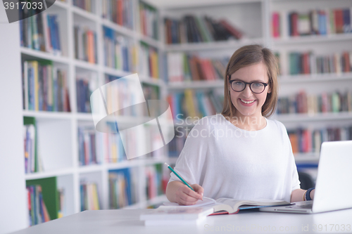 Image of female student study in school library