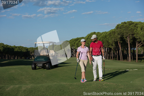 Image of couple walking on golf course